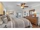 Spacious bedroom with a large bed, dresser, and access to a patio at 2198 El Cerito Ct, Punta Gorda, FL 33950