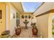 Charming courtyard with fountain, potted plants, and arched entryway at 2198 El Cerito Ct, Punta Gorda, FL 33950