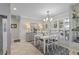 Elegant dining room with white table and chairs, gray buffet, and window shutters at 2198 El Cerito Ct, Punta Gorda, FL 33950