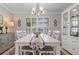 Elegant dining room with white table, chandelier, and built-in hutch at 2198 El Cerito Ct, Punta Gorda, FL 33950