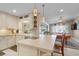 Open kitchen with breakfast bar, stainless steel appliances, and pool view at 2198 El Cerito Ct, Punta Gorda, FL 33950