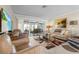 Spacious living room with leather furniture, large TV and access to patio at 2198 El Cerito Ct, Punta Gorda, FL 33950