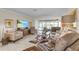 Comfortable living room with leather furniture, large TV, and sliding doors to patio at 2198 El Cerito Ct, Punta Gorda, FL 33950
