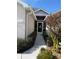 Front entry with decorative screen door and walkway at 24148 Buckingham Way, Port Charlotte, FL 33980