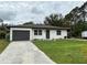 Newly renovated home with a large front yard and driveway at 28301 N Twin Lakes Dr, Punta Gorda, FL 33955