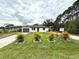 Newly renovated home with a manicured lawn and tropical plants at 28301 N Twin Lakes Dr, Punta Gorda, FL 33955