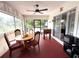 Relaxing screened porch with foosball table, dining set and ceiling fan at 28301 N Twin Lakes Dr, Punta Gorda, FL 33955