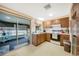 Cozy kitchen with wood cabinets and access to a screened porch at 3196 Elkcam Blvd, Port Charlotte, FL 33952