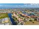 Aerial view of a condo complex on a waterway, boats docked, surrounded by residential areas at 3329 Purple Martin Dr # 113, Punta Gorda, FL 33950