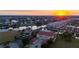 Aerial view of waterfront condos at sunset, featuring boat docks and canal access at 3329 Purple Martin Dr # 113, Punta Gorda, FL 33950