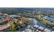 High aerial view of a condo building next to a canal with boats docked, in a residential neighborhood at 3329 Purple Martin Dr # 113, Punta Gorda, FL 33950