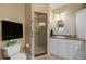 Bright bathroom with a toilet, sink, stone countertops, custom cabinets and a glass enclosed shower at 3329 Purple Martin Dr # 113, Punta Gorda, FL 33950