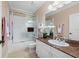 Clean bathroom featuring a shower-tub combination and white vanity with marble countertop and a decorative mirror at 3329 Purple Martin Dr # 113, Punta Gorda, FL 33950