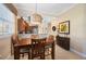 Warm dining area with a pendant light fixture and a glimpse of the stainless steel kitchen appliances at 3329 Purple Martin Dr # 113, Punta Gorda, FL 33950