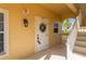 Charming condo entrance featuring unit number 113, a welcoming wreath, and well-lit access at 3329 Purple Martin Dr # 113, Punta Gorda, FL 33950