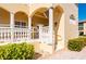 Inviting condo exterior featuring an accessible ramp, classic columns, and well-maintained landscaping at 3329 Purple Martin Dr # 113, Punta Gorda, FL 33950
