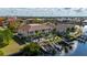 Waterfront condo featuring a private boat dock, lush landscaping, and a shared community pool at 3329 Purple Martin Dr # 113, Punta Gorda, FL 33950