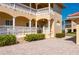 Charming condo building with tan exterior, decorative railings, an accessible ramp, and manicured landscaping at 3329 Purple Martin Dr # 113, Punta Gorda, FL 33950