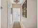 Inviting hallway with decorative rug, neutral walls, and tasteful artwork leading to the home's entrance at 3329 Purple Martin Dr # 113, Punta Gorda, FL 33950