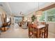 Bright and airy living room and dining area featuring a ceiling fan, stylish lighting, and large windows at 3329 Purple Martin Dr # 113, Punta Gorda, FL 33950