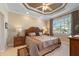 Serene main bedroom with a tray ceiling, decorative lamps, and a large window with natural light at 3329 Purple Martin Dr # 113, Punta Gorda, FL 33950