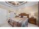 Comfortable main bedroom with a tray ceiling, bedside tables, and an ensuite bathroom access at 3329 Purple Martin Dr # 113, Punta Gorda, FL 33950