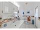 Bathroom featuring a vanity with ample storage, marine themed accents and a well-lit mirror at 3339 Desoto Dr, Punta Gorda, FL 33983