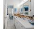 Bathroom featuring a large vanity, white cabinets, with charming nautical accents and decor at 3339 Desoto Dr, Punta Gorda, FL 33983