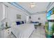 Bright bedroom featuring coastal themed decor and an inviting atmosphere, complete with a cozy sitting area at 3339 Desoto Dr, Punta Gorda, FL 33983