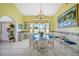 Bright dining room with chandelier, glass table, and white chairs near the windows at 3339 Desoto Dr, Punta Gorda, FL 33983