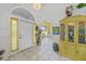Bright foyer featuring tile floors, arched doorway, and lovely cabinet with display lighting at 3339 Desoto Dr, Punta Gorda, FL 33983