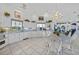 Bright kitchen features white cabinetry, tile backsplash, modern appliances, and a charming chandelier at 3339 Desoto Dr, Punta Gorda, FL 33983