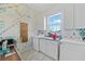 Bright laundry room with a window, white cabinetry, washer, and dryer at 3339 Desoto Dr, Punta Gorda, FL 33983