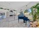Spacious living area with soaring ceilings, a blue piano, stone fireplace, and ample natural light at 3339 Desoto Dr, Punta Gorda, FL 33983