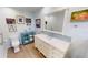 Bright bathroom featuring a white vanity, wooden floors, and colorful art at 3830 Bal Harbor Blvd # 6, Punta Gorda, FL 33950