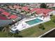 Community pool with ample lounge seating surrounded by lush landscaping and white picket fence at 3830 Bal Harbor Blvd # 6, Punta Gorda, FL 33950
