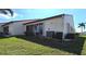 The back of the house features sliding doors, a lawn, and access to outdoor living at 3830 Bal Harbor Blvd # 6, Punta Gorda, FL 33950