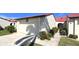 Charming home exterior with a well-maintained garage, landscaping, and red roof at 3830 Bal Harbor Blvd # 6, Punta Gorda, FL 33950