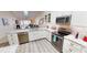 Well-lit kitchen features white cabinetry, granite countertops, and modern stainless steel appliances at 3830 Bal Harbor Blvd # 6, Punta Gorda, FL 33950