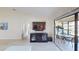 Well-lit living room featuring a large television and seamless access to the screened patio at 3830 Bal Harbor Blvd # 6, Punta Gorda, FL 33950