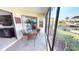 Screened patio with views of the waterway, with comfortable seating and tropical plants at 3830 Bal Harbor Blvd # 6, Punta Gorda, FL 33950