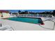 Community pool with crystal-clear water, bordered by white fencing and poolside furniture at 3830 Bal Harbor Blvd # 6, Punta Gorda, FL 33950