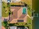 Aerial view of a home with a tile roof, pool, dock, and well-manicured lawn and landscaping at 400 Coronado Dr, Punta Gorda, FL 33950