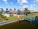 Beautiful home featuring a boat lift, enclosed pool, and well-maintained lawn, perfect for enjoying coastal lifestyle at 400 Coronado Dr, Punta Gorda, FL 33950