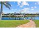 Brick path leads to a boat lift, and a vibrant green lawn, perfect for enjoying outdoor activities at 400 Coronado Dr, Punta Gorda, FL 33950