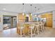 Kitchen island featuring bar seating and views of the pool area through sliding glass doors at 400 Coronado Dr, Punta Gorda, FL 33950