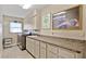 Practical laundry room features ample counter space, cabinets, and modern washer and dryer at 400 Coronado Dr, Punta Gorda, FL 33950