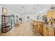 Open concept living space with a kitchen island, bar seating, and a view of a sunlit living room at 400 Coronado Dr, Punta Gorda, FL 33950