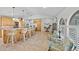 Bright and airy living space with an open layout showcasing the kitchen, bar seating, and casual living area at 400 Coronado Dr, Punta Gorda, FL 33950