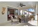 Relaxing covered patio with comfortable seating area and sliding door to the inside at 400 Coronado Dr, Punta Gorda, FL 33950